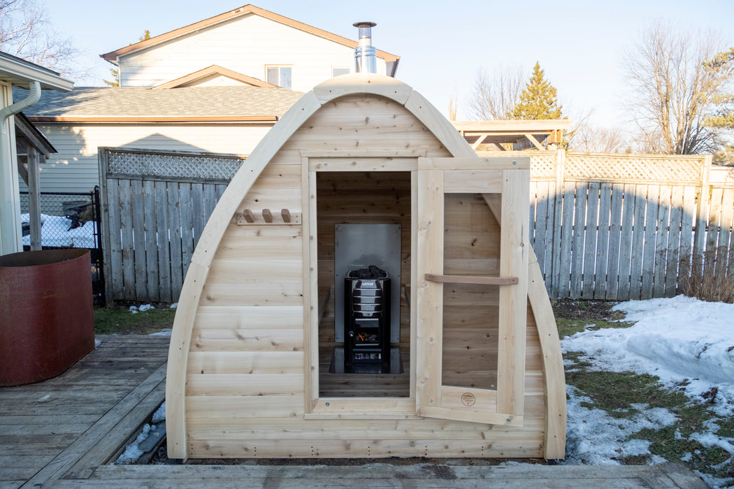 CT MiniPOD Sauna: 7x7, Handcrafted in Canada, 1.5" Eastern White Cedar, Seating for 4, Tempered Glass Door, Asphalt Shingles, Wood Burning or Electric Heater Options.